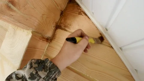 Construction work with a brush in a house built of wood Stock Footage 95618915