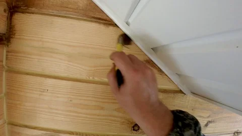 Construction work with a brush in a house built of wood Stock Footage 95618930