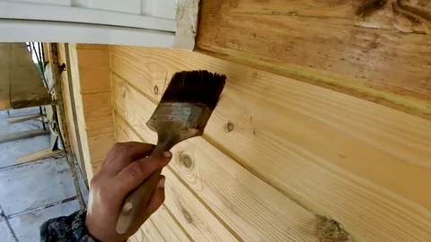 Construction work with a brush in a house built of wood Stock Footage 95619348