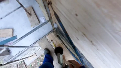 Construction work with a brush in a house built of wood Stock Footage 95663360