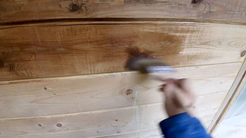 Construction work with a brush in a house built of wood Stock Footage 95663380