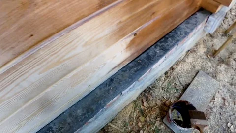 Construction work with a brush in a house built of wood Stock-Footage 95821807