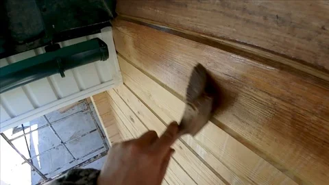 Construction work with a brush in a house built of wood Stock-Footage 95991687