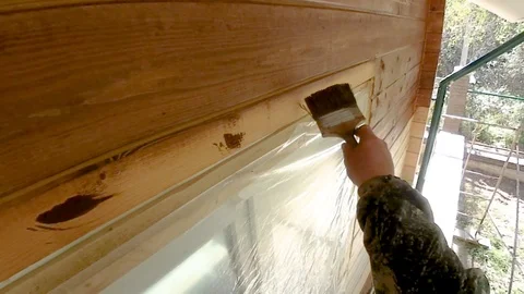 Construction work with a brush in a house built of wood Stock-Footage 96025191