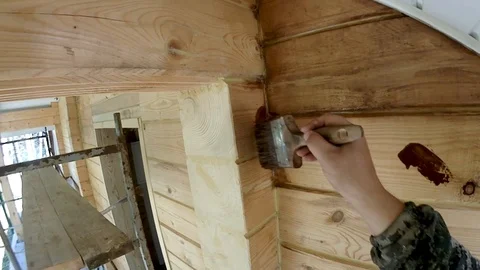 Construction work with a brush in a house built of wood Stock-Footage 96025222