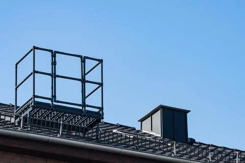 Construction work on a building rooftop during clear sky Foto stock