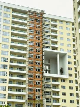 Construction work on a building with scaffolding in a city setting during d.. Stock Photos