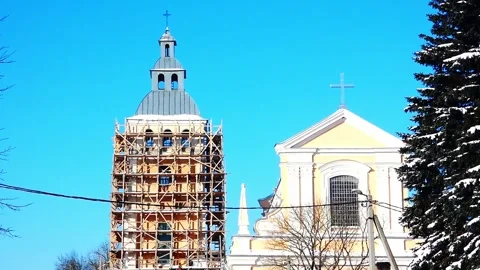 Construction work on church bell tower in winter under clear blue sky Stock-Footage 328116996