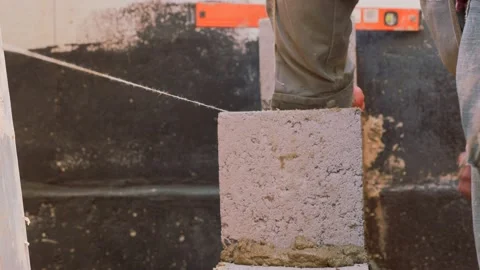 Construction work. Cinder block laying. Work of masons. Stock Footage 141383342
