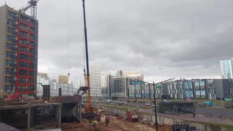 Construction work in a city area with cranes and buildings under development in Stock Footage 325802762