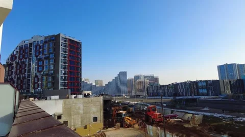 Construction work in city area with tall buildings and clear blue sky Stock Footage 331370617