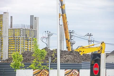 Construction work with a construction crane and skyscrapers against a cloud.. Stock Photos