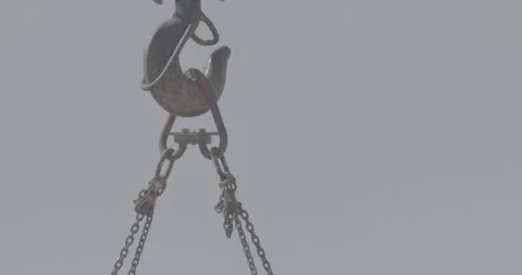 Construction work, a construction hook lifts something on chains Stock Footage 305641068