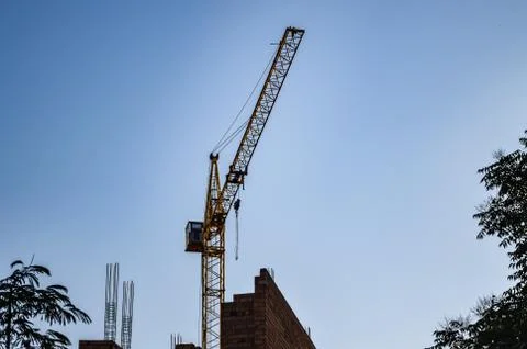 Construction work with a crane against the blue sky Stock Photos