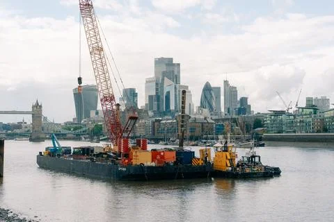 Construction work with cranes on pontoon barges on the River Thames in Lond.. Stock Photos