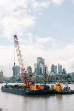 Construction work with cranes on pontoon barges on the River Thames in Lond.. Stock Photos