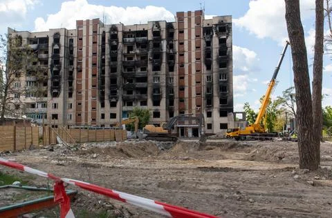 Construction work on the demolition of multi-storey apartments. Fence made of Stock Photos
