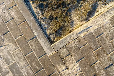 Construction work during landscaping, the sand filling the tile joints fell o Stock Photos