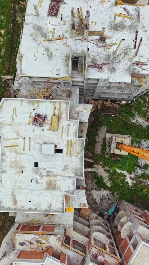 Construction work happening on a multi-storey building showing the rooftop and Stock Footage 337906931