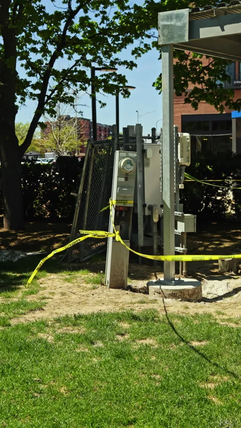 Construction work is happening near an electrical meter in a park area with Stock Footage 339499402