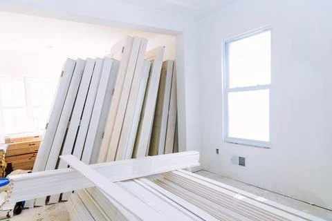 Construction work on installation of interior wooden doors is in progress in a Stock Photos