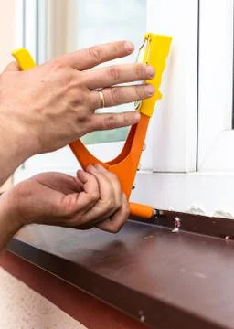 Construction work - installation of rivets. Window tint repair. Plastic windows. Stock Photos