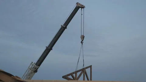 Construction work. Installation of a wooden truss on the roof of a private house Stock Footage 165769558