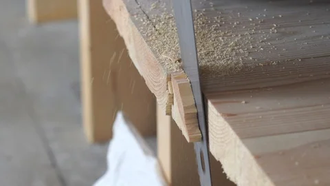 Construction work - a man sawing sawn wooden floor boards Stock Footage 106525645
