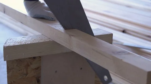 Construction work - a man sawing sawn wooden floor boards Stock Footage 107841795