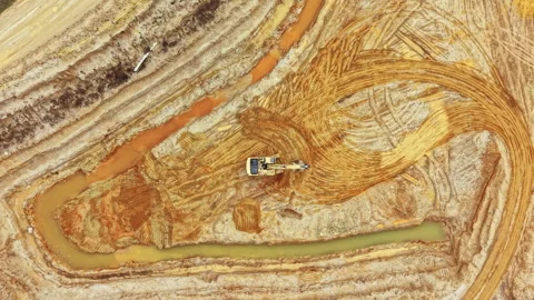 Construction work occurs in a large area with machinery moving earth and shaping Stock Footage 336514426