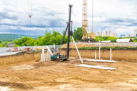 Construction work in a pit - a pile foundation for a heavy structure with soft Stock Photos