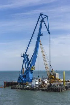 Construction work at the port dock crane in the bay of the sea 스톡 사진