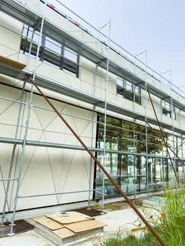Construction work in progress on a building with scaffolding and tools on t.. Stock Photos
