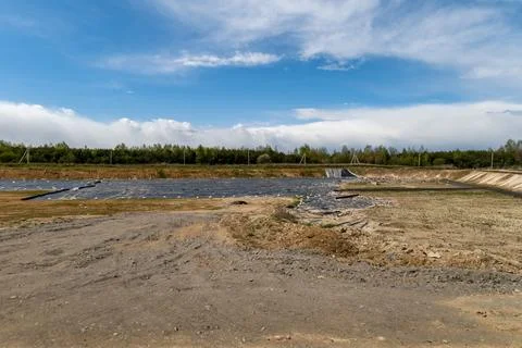 Construction work is in progress at a new landfill site with covered areas .. Stock-Fotos