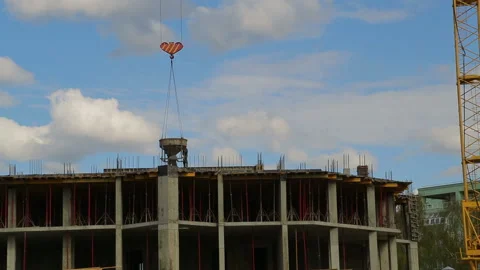Construction work with rooftop workers and a tower crane raising construction Видео 107785737