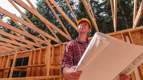 Construction work on site with building plans Stock Footage 212412572