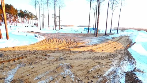 Construction work on a snowy site during daylight hours in a forest area Stock Footage 328138739