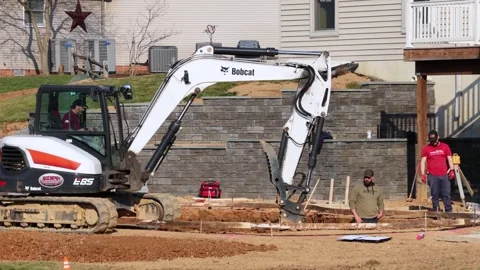 Construction work in suburban American backyard with an excavator digging pool Stock Footage 333611245