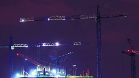 Construction work at sunset. Tower cranes are used to complete the task quickly. Stock Footage 12250076