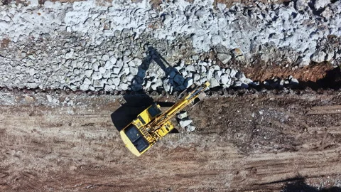 Construction work takes place on a building site with heavy machinery moving Stock Footage 337908327