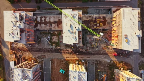 Construction work takes place in a building site with cranes and multiple Stock Footage 341596092