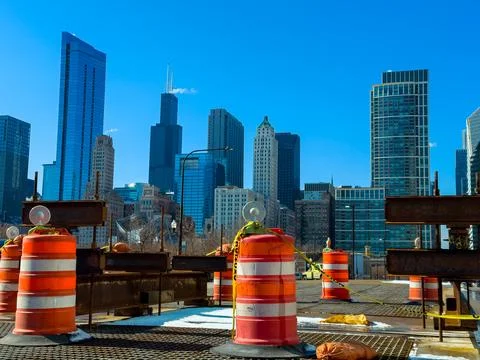 Construction work takes place in Chicago with orange cones marking the area.  Fotos Stock