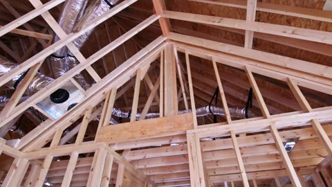 Construction work takes place in new building with exposed framework, ductwork Vídeos de archivo 338116997