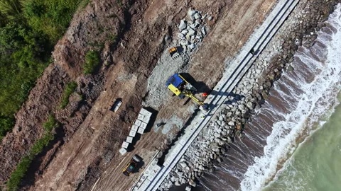 Construction work is taking place by the beach to build a new pathway along the Stock Footage 337883792