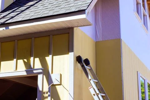 Construction work is taking place on building with ladder propped against Stock Photos