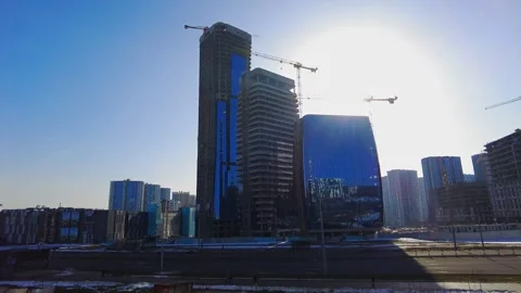 Construction work in an urban area with buildings and a clear sky during the day Video stock 331370725