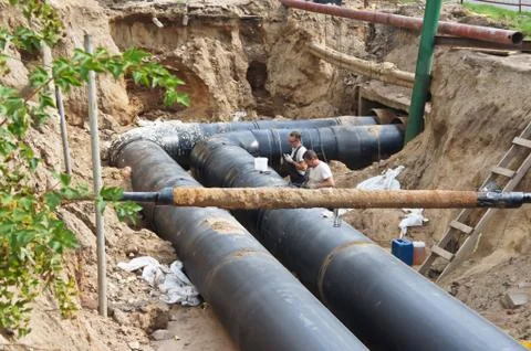 Construction work. Workers. Pipe laying. Repair of communications. Stock Photos