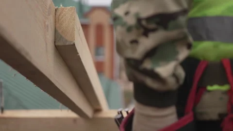 Construction worker actively hammers nails into wooden beam Stock-Footage 311105685