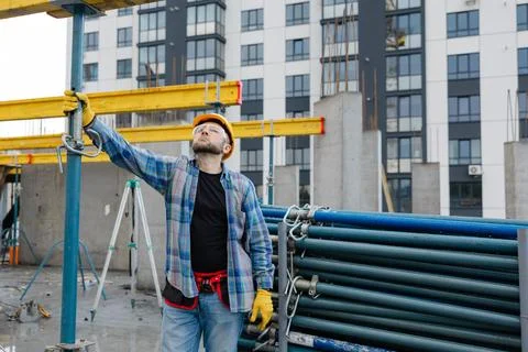 Construction worker adjusting formwork system on building site Stock Photos