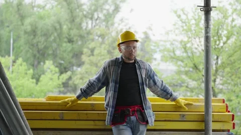 Construction worker adjusting hard hat on site Stock Footage 337467586